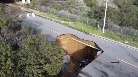 Large-Sink-hole-forms-in-road