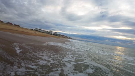 Flying-an-FPV-drone-over-the-waves-on-the-wild-beach-of-Hossegor-on-a-cloudy-day