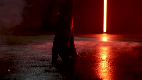 woman-standing-in-boots-on-wet-and-foggy-street-in-slow-motion