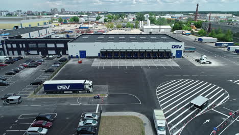 DSV-logistic-center-with-many-docks-for-trucks,-aerial-fly-forward-view