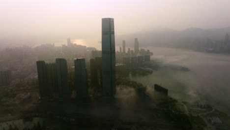 High-skyscraper-Union-Square-in-Hong-Kong-with-low-hanging-morning-fog-during-sunrise