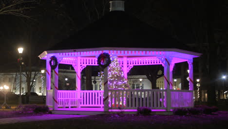 Wooden-Gazebo-Illuminated-By-Christmas-Lights-With-Wreath-At-Night