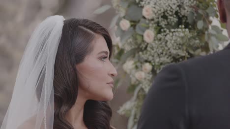 Young,-beautiful-bride-nodding-as-she-listens-to-wedding-talk