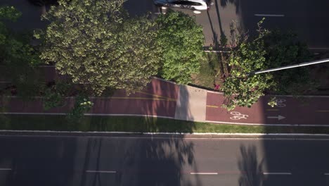 Drone-view-of-a-bike-crossing-the-frame-in-a-bike-lane