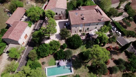Aerial-rotating-drone-shot-of-an-expensive-neighborhood-with-private-pools-in-France