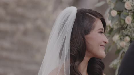 Beautiful,-young-bride-nodding-and-laughing-as-she-says-"I-do
