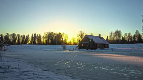 Time-laps-clear-sky-sunset-over-cottage-on-snow-land