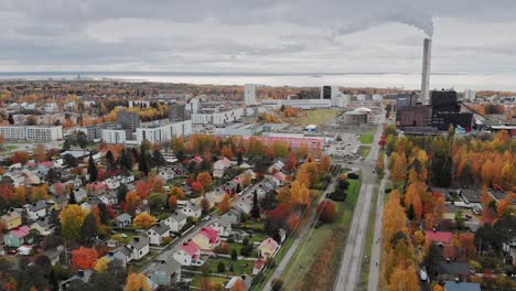 Power-plant-and-residential-area-in-Oulu,-Baltic-Sea-in-the-background