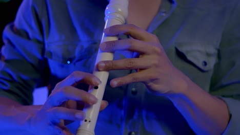 Close-Up-Shot-Of-Musician's-Hands-Playing-Recorder