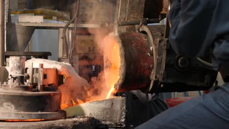 Workers-pouring-smoking-melted-metal-at-factory---close-up