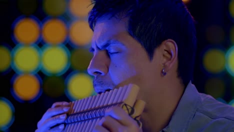 Close-Up-Shot-Of-Musician-Playing-Pan-flute-Instrument-From-Andes-Of-Peru-And-Bolivia