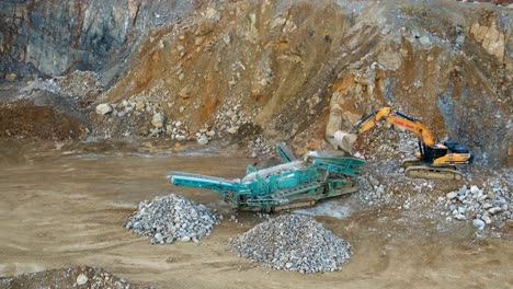 Separating-Rock-and-Gravel:-An-Aerial-Look-of-an-Excavator-feeding-a-Tracked-Incline-Screener-in-a-Mining-Quarry