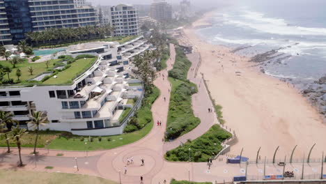 Aerial-drone-along-Umhlanga-ocean-promenade-with-the-Pearls-Residence-and-Umhlanga-Pier-being-revealed