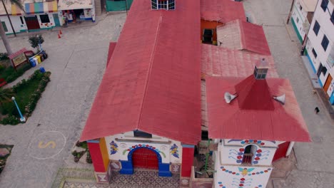 Overtake-Shot-Of-Distinctive-Colorful-Church-In-Antioquia-Town,-Peru,-Lima