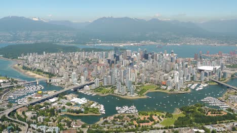Experience-the-stunning-beauty-of-Vancouver,-BC-like-never-before-with-this-breathtaking-aerial-footage-showcasing-the-city's-iconic-skyline,-picturesque-mountains-and-sparkling-waterways