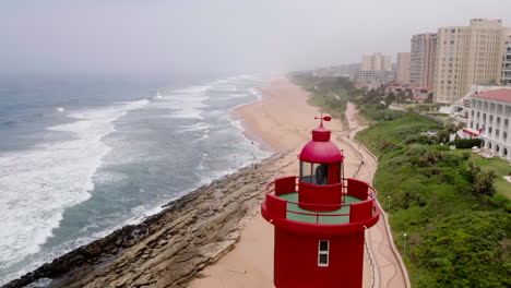 Aerial-drone-shot-revealing-the-Unmhlanga-Lighthouse-and-Oysterbox-Luxury-Hotel-in-Durban-South-Africa