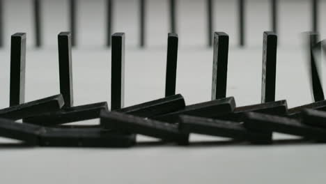 rows-of-black-dominoes-in-a-white-studio