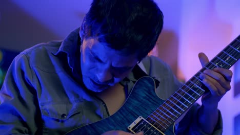 Slow-Motion-Shot-Of-Musician-Playing-Guitar,-Nodding-His-Head-With-Passion