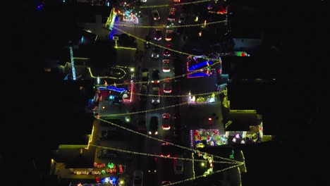 Christmas-along-a-main-street-in-a-downtown-neighborhood---aerial-flyover