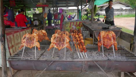 Asian-cooks-grilling-barbecued-chicken-skewers-at-an-outdoor-street-market