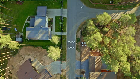 Areal-flyover-in-Birdseye-perspective-of-a-suburban-neighbourhood-in-a-lush-forest-on-a-sunny-day