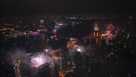 Elaborate-Firework-Display-over-Hong-Kong-Island-Skyline-at-Night,-Wide-Angle-Aerial-Shot