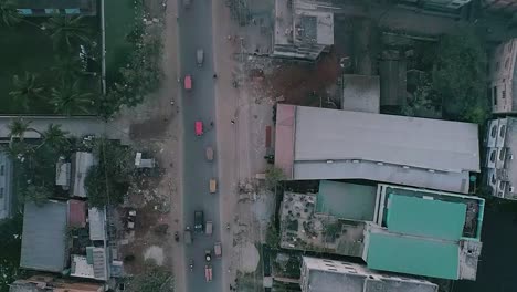 Drone-shot-of-a-road-from-rural-city-vehicles-are-passing