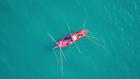 Aerial-view-drone-tracking-a-tourist-thai-longtail-fishing-boat-in-phuket-islands,Amazing-andaman-sea-in-Phuket-Thailand-on-a-sunny-morning-with-beautiful-sea-background