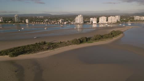 Aerial-view-over-Curlew-Island-on-the-Broadwater-on-the-Gold-Coast-moving-towards-Surfers-Paradise,-Queensland,-Australia