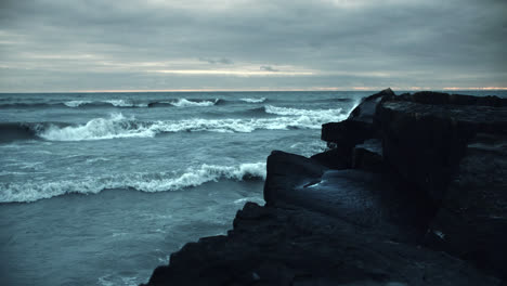 Powerful-Iceland-Storm-Waves-Crashing-against-Black-Beach-Rock-Cliffs