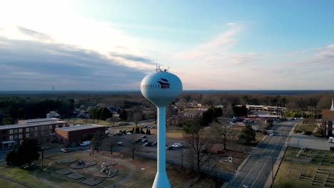 Small-town-orbit-aerial-of-water-tower-in-Lewisville-North-Carolina