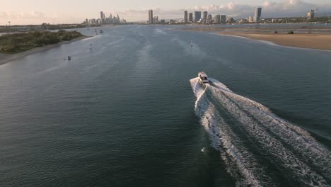 Aerial-view-over-a-boat-on-the-Broadwater-moving-towards-Surfers-Paradise-on-the-Gold-Coast-moving-towards-Surfers-Paradise,-Queensland,-Australia