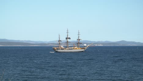Establisher-shot-of-magnificent-Amerigo-Vespucci-tall-ship-off-Sardinian-coast