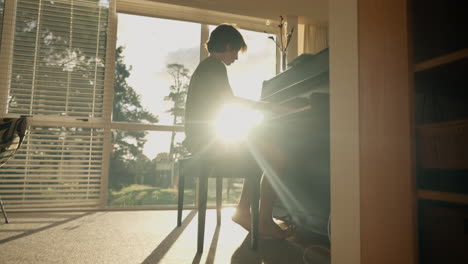 Young-boy-plays-piano-at-home