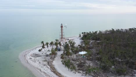4K-Aerial-drone-clip-flying-over-the-Sanibel-Lighthouse-towards-a-boat-in-Sanibel,-FL