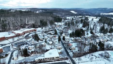 Snow-falling-over-small-American-town,-Wellsboro