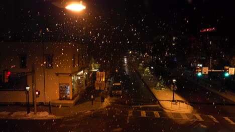 Heavy-snow-falling-underneath-street-light-at-night