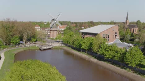 Citypark-in-north-germany-with-windmill-and-curch-in-Papenburg-at-a-beautiful-spring-day