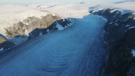 Drone-footage-of-longest-glacier-arm-in-Europe---Tunsbergdalsbreen-glacier-Jotedalsbreen-National-Park,-Norway-at-sunrise