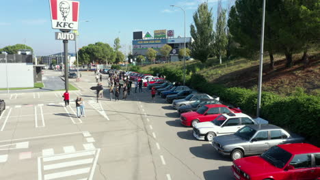 Aerial-view-over-row-parked-BMW-series-classic-e30-cars-at-fan-meeting-in-KFC-restaurant-car-park