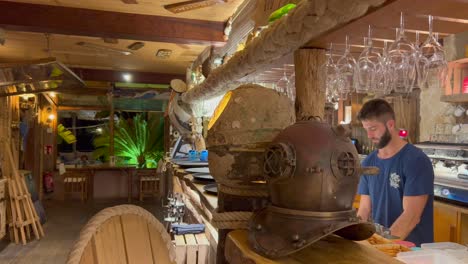 Beautiful-ocean-themed-bar-at-the-restaurant-Boat-House-in-Ibiza-Spain,-cool-sea-fishing-decorations-design,-4K-shot