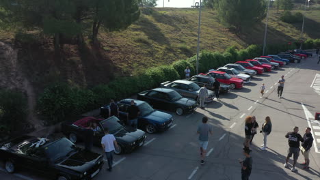 Aerial-view-across-row-of-parked-BMW-series-classic-e30-cars-at-fan-club-car-show-meeting