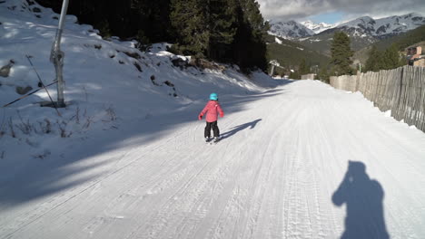Little-girl-having-fun-learning-to-ski-on-French-Andorra-winter-resort-slope