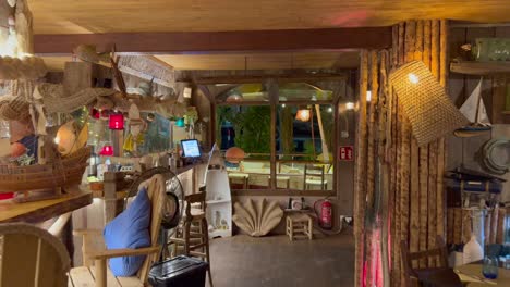 Beautiful-ocean-themed-bar-at-the-restaurant-Boat-House-in-Ibiza-Spain,-cool-sea-fishing-design-decorations,-4K-shot
