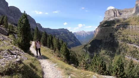 Hiker-walking-along-the-Senda-de-los-Cazadores-in-the-Ordesa-Valley,-Huesca,-Spain