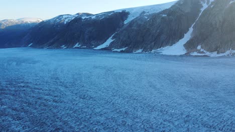 Drone-footage-of-Tunsbergdalsbreen-glacier-in-Jostedalsbreen-National-Park,-Norway-at-sunset