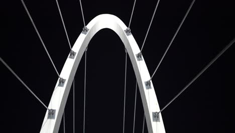 Abstract-arch-city-bridge-architecture-with-cables-and-metal-frame-at-night