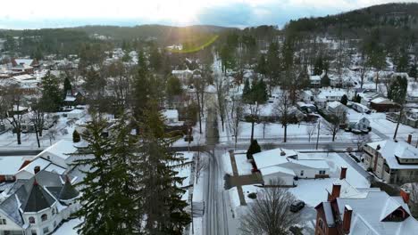 Aerial-descending-shot-of-snow-falling-on-quaint-neighborhood-in-America