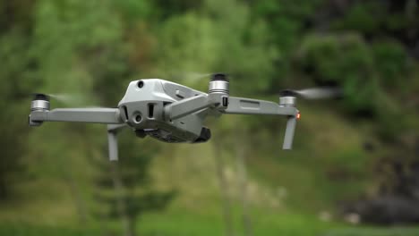 Close-up-shot-of-dji-quadcopter-fling-in-nature-in-front-of-forest-And-waterfall