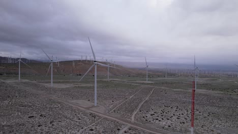 Aerial-footage-of-a-wind-farm-in-the-Palm-Springs-desert-on-a-cloudy-day,-steady-wide-shot